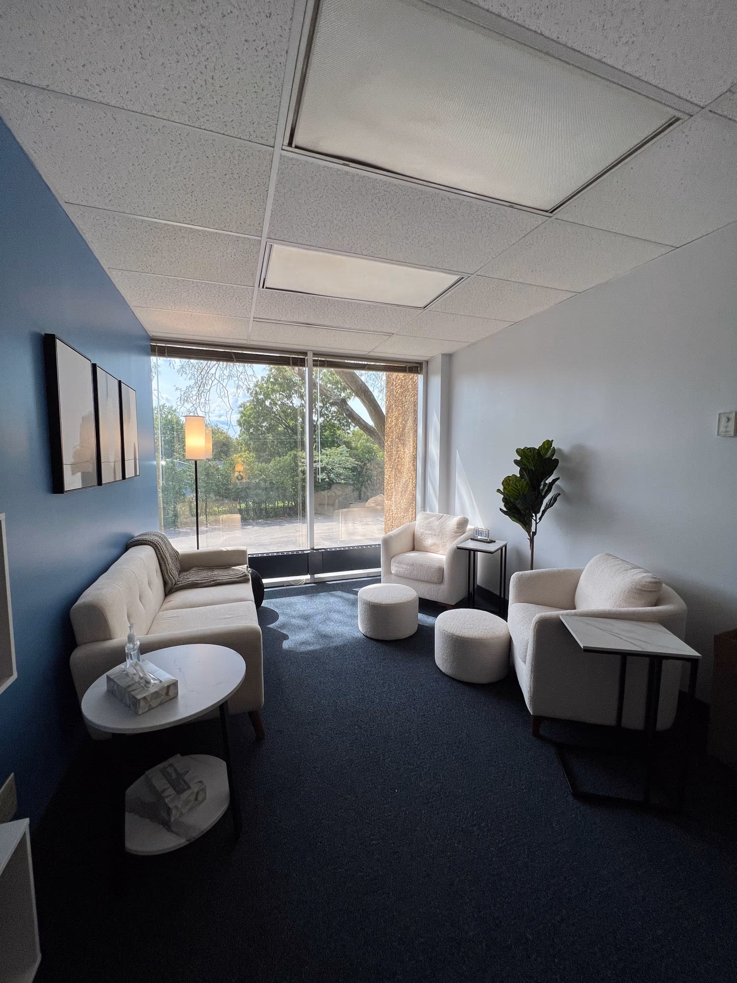 A wide view of the seating area and windows in Gabby Silone's office at ABHS